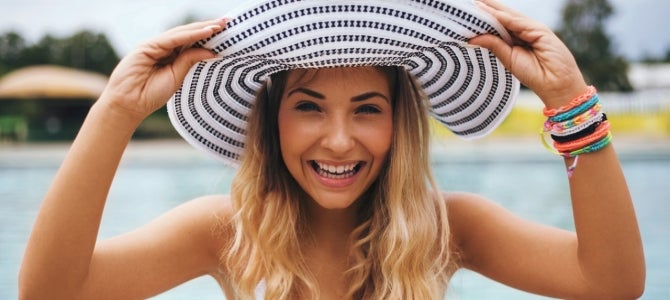 under eye care 2 girl at a pool wearing a sun hat